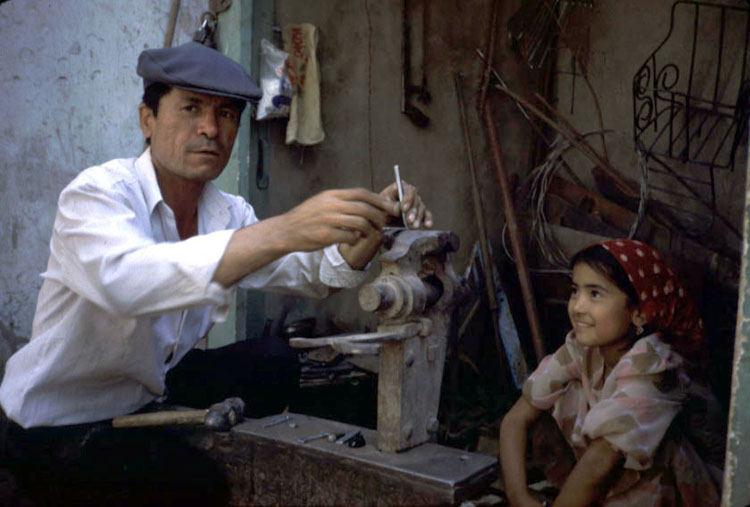 In Kashgar, this blacksmith made new clips for Alex's panniers.