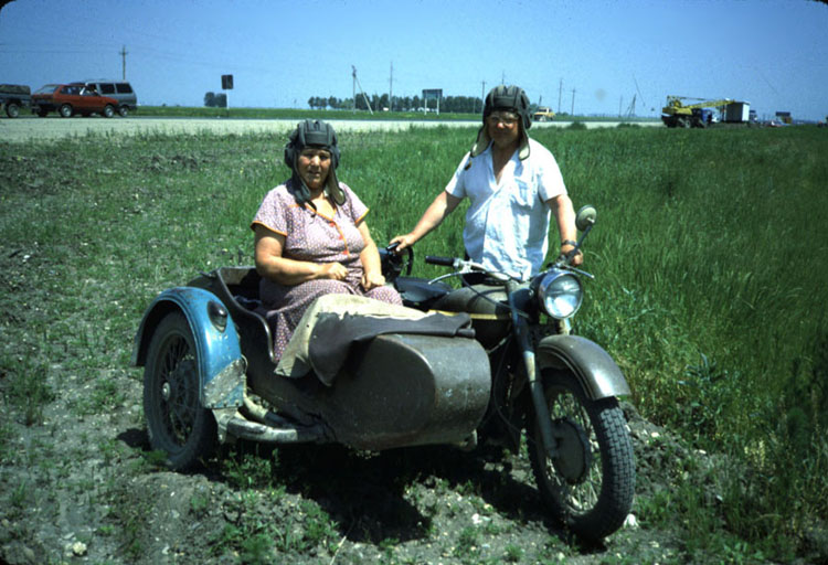 Everyone traveled on these 1950's motorcycles with sidecars. World War II aviator helmet optional.