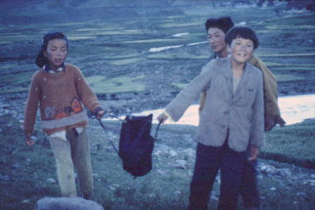 Native kids helping carry one of our MSR dromedary bags near Golmud. They were rugged - the kids and the dromedaries.